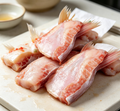Fresh white fish fillets with a glossy pinkish-white surface